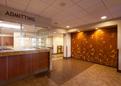 A spacious and modern waiting area with a reception desk, designed for comfort and accessibility.