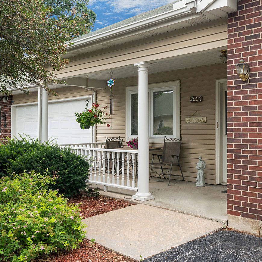 A cozy suburban home with a front porch and garage entrance.