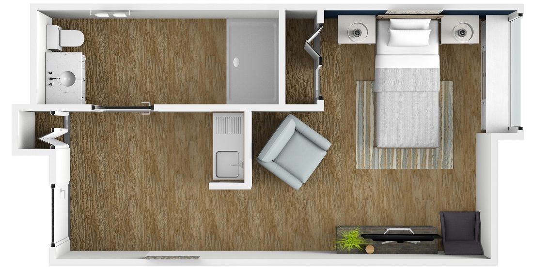 A top-down view of a bedroom floor plan featuring a bed, an armchair, and an adjacent bathroom.