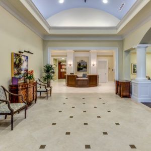 Elegant lobby with a central reception desk and decorative elements.