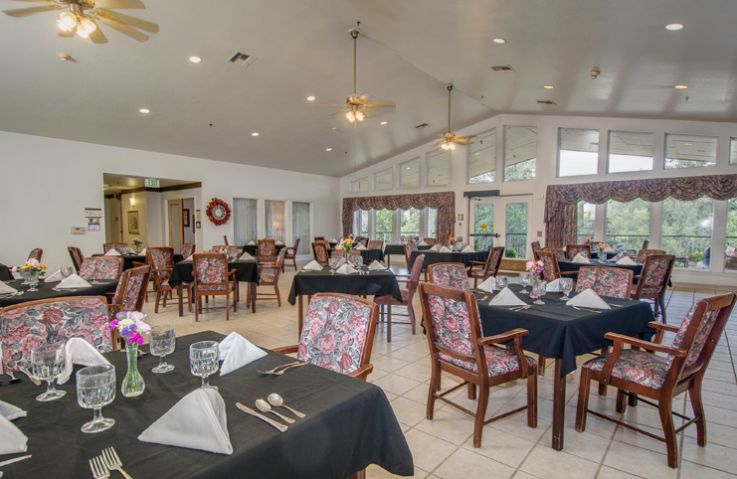 A well-decorated restaurant dining area with neatly set tables and chairs.