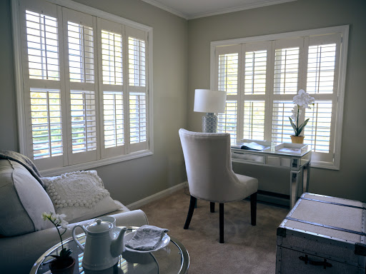 A bright and serene home office space featuring elegant furniture and soft natural light.