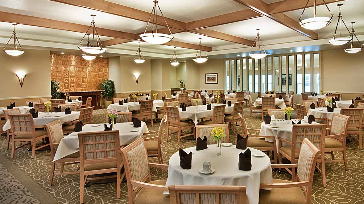 Elegant dining room interior with tables set for guests.