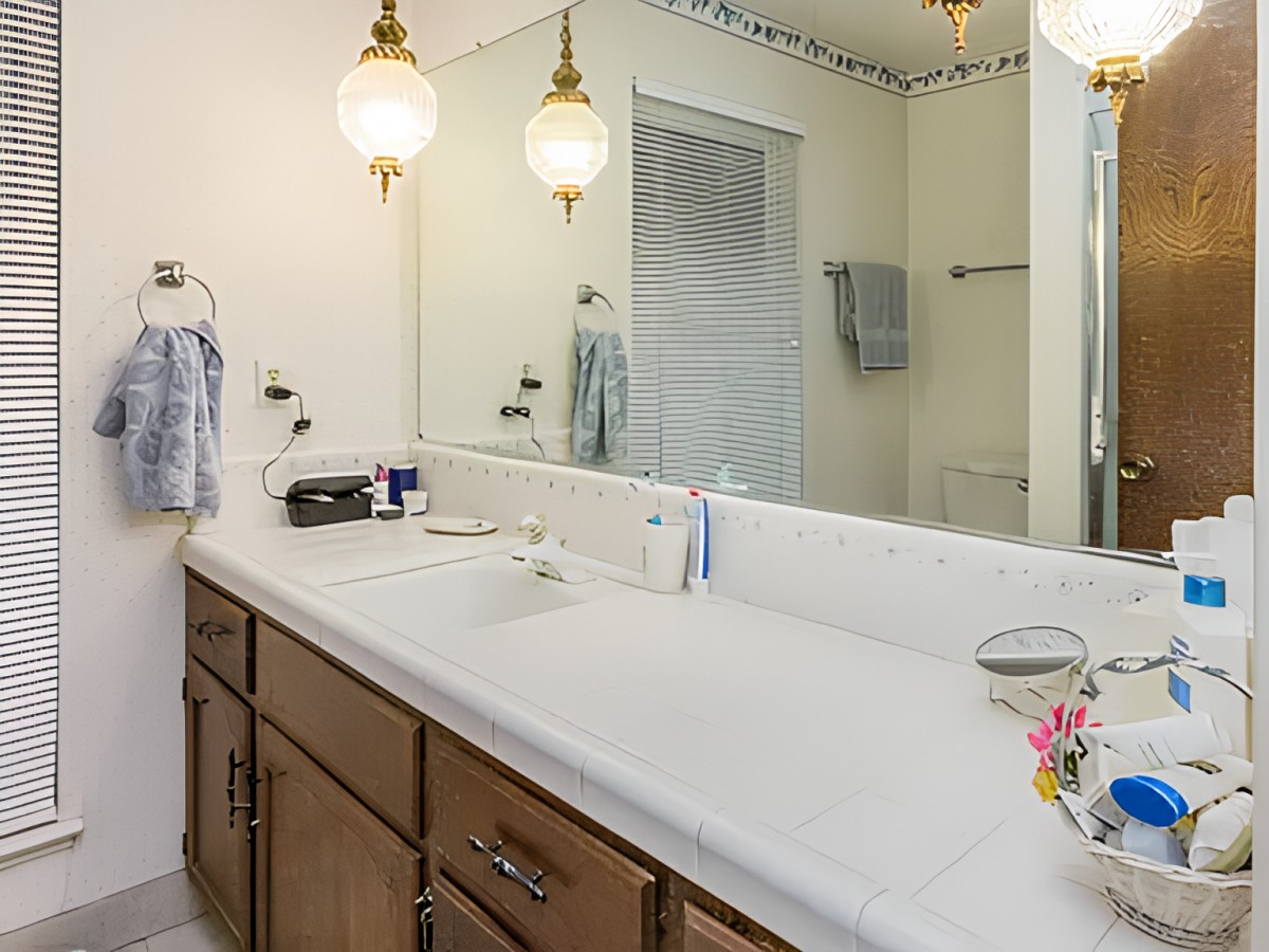 A clean and tidy bathroom with a large mirror and double sink.