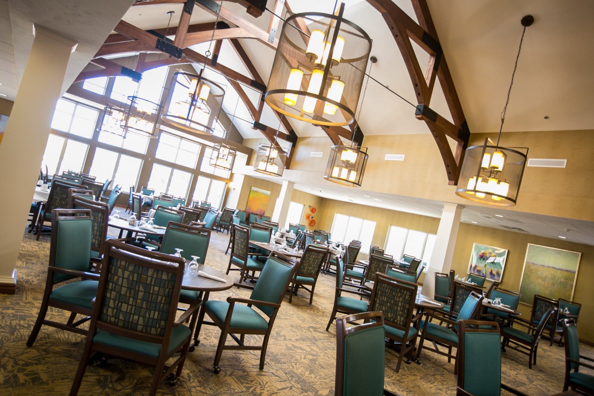 Spacious dining area with elegant lighting and ample seating.