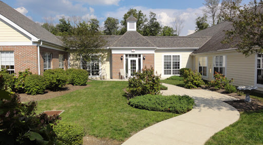 A beautifully landscaped exterior of a building, featuring a well-maintained garden and a winding pathway.