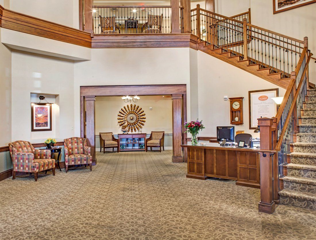 A welcoming hotel lobby with a reception desk and comfortable seating area.