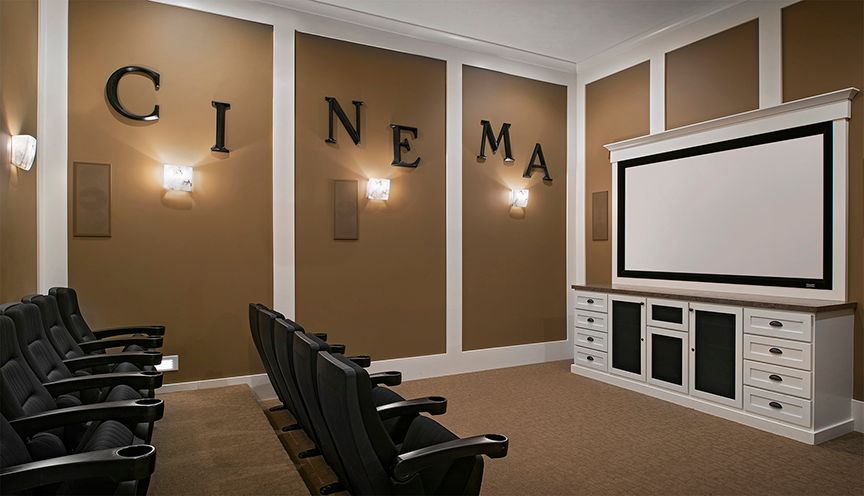 A cozy home theater with comfortable seating and a large screen, perfect for movie nights.
