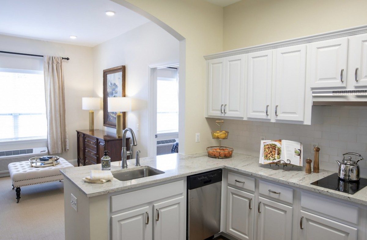 A modern kitchen with white cabinets and a sleek design.
