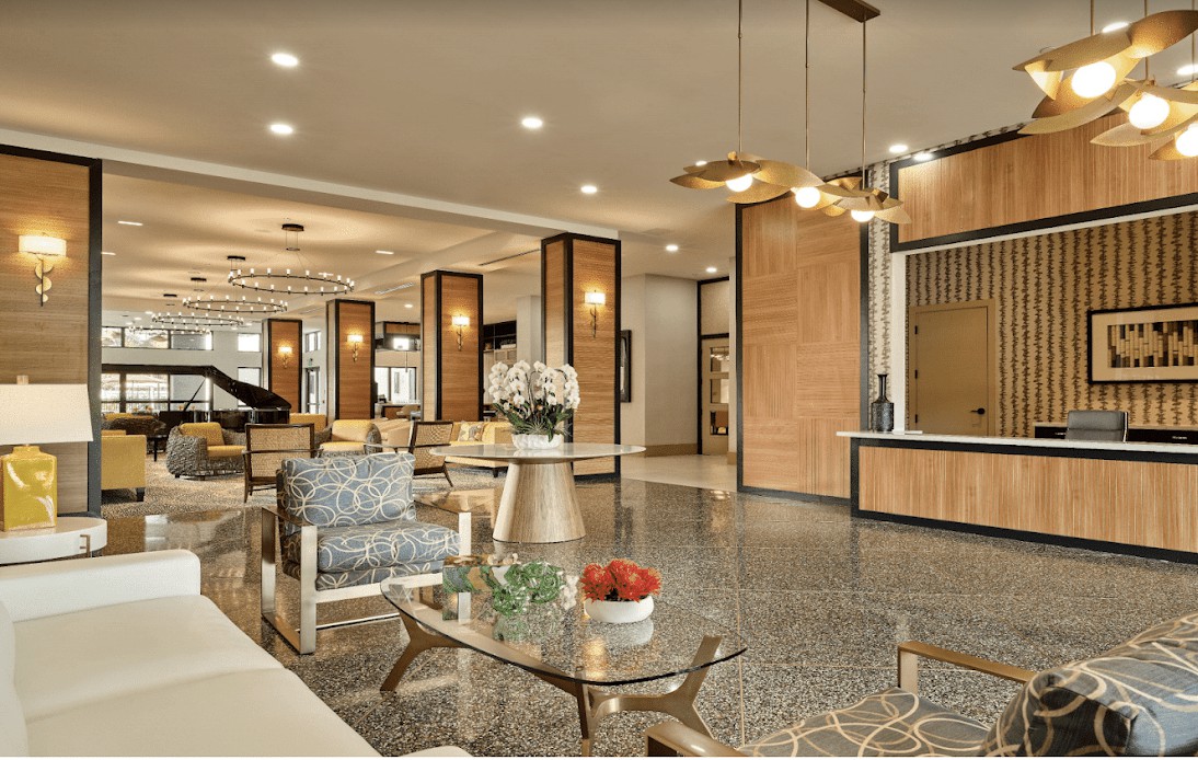 A modern hotel lobby with elegant furniture and warm lighting.