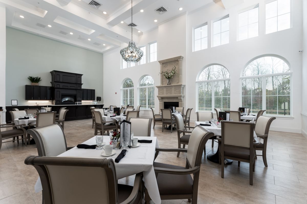 A luxurious dining room with elegantly set tables and comfortable seating.
