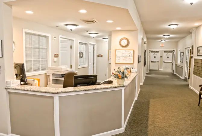 A welcoming reception area with a desk and adjacent hallway.