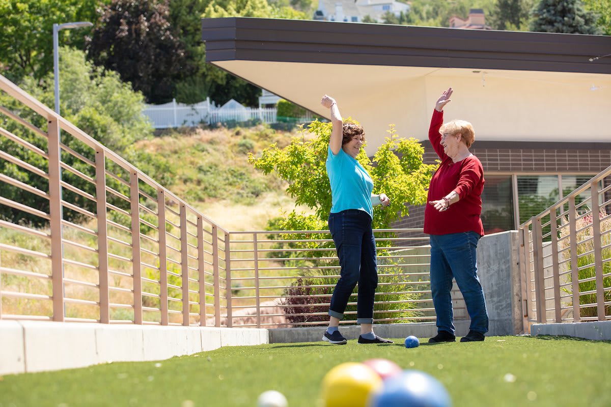 Two people enjoying a game on a sunny day outdoors.