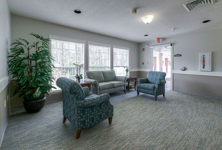 A cozy living room with comfortable seating and large windows.
