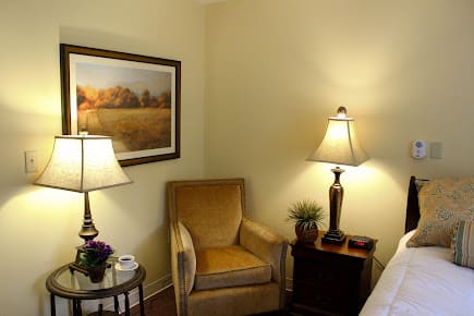 Cozy living room corner with a comfortable chair and warm lighting.