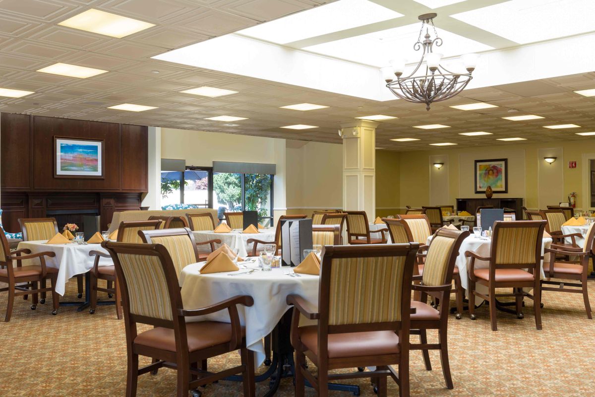 Elegant dining area with neatly set tables and comfortable seating.