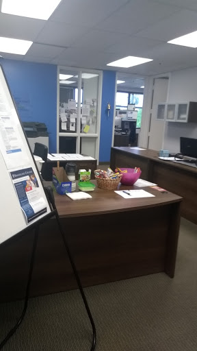 A well-organized office space featuring a reception area with various items on the desk.