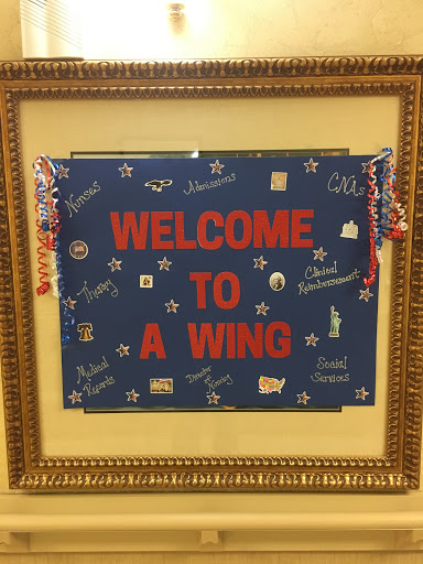 A vibrant welcome sign featuring decorative elements, framed elegantly.