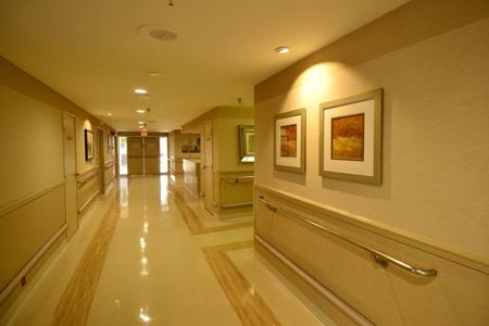A well-lit and clean hospital hallway adorned with modern art.