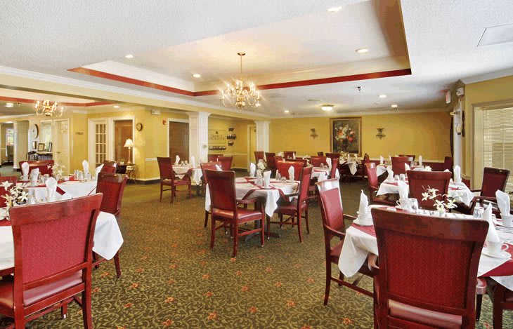 An elegant restaurant dining room with neatly arranged tables and chairs.