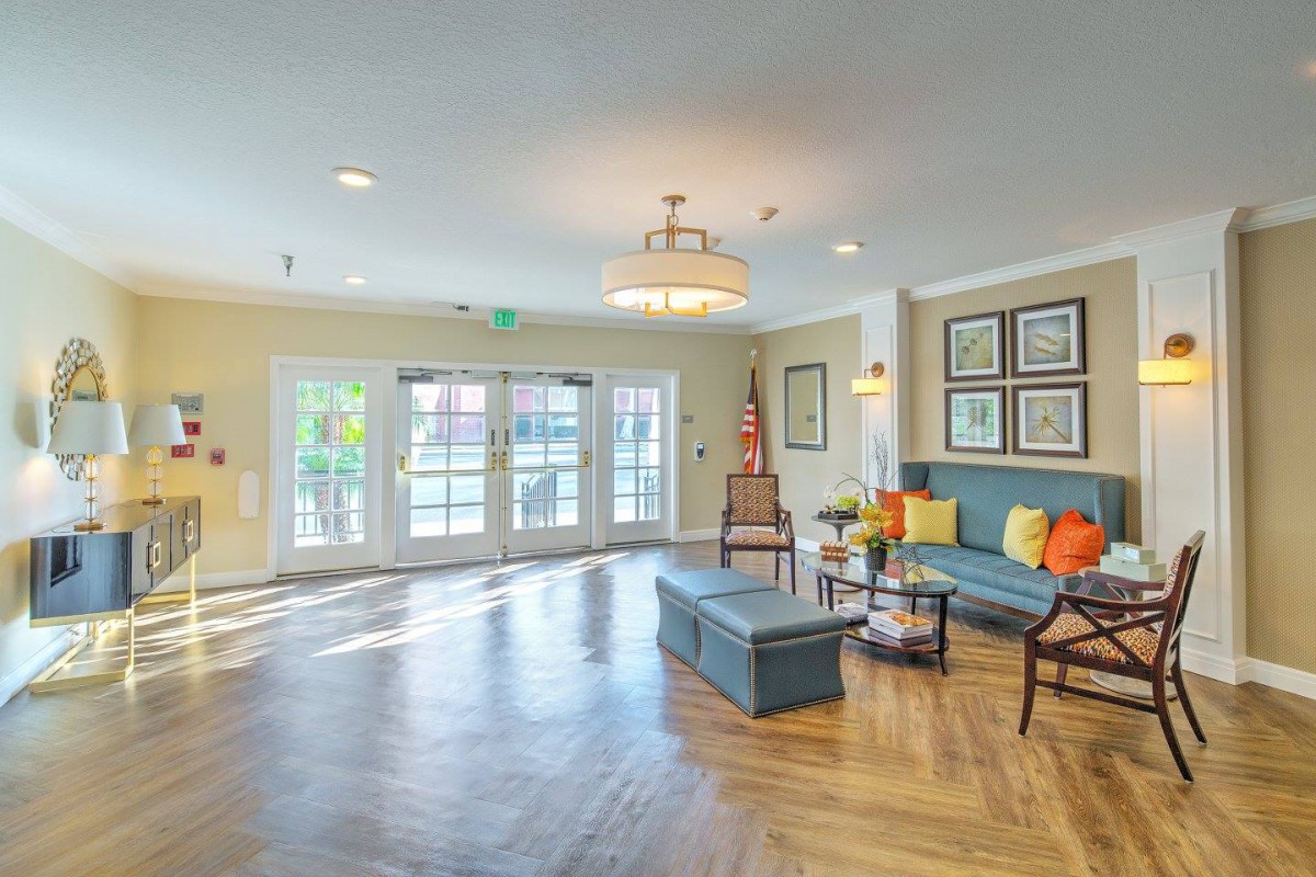 A spacious and elegantly designed living room with wooden flooring, comfortable seating, and tasteful decor.