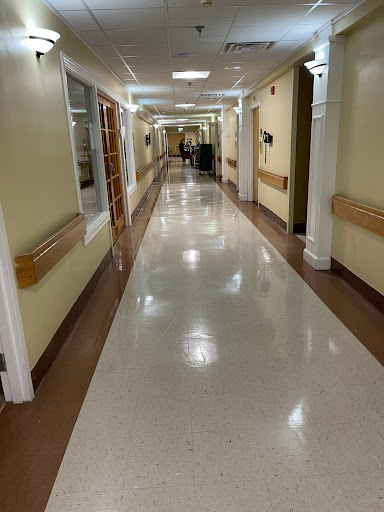 A quiet corridor in a hospital, showcasing the indoor environment and lighting.