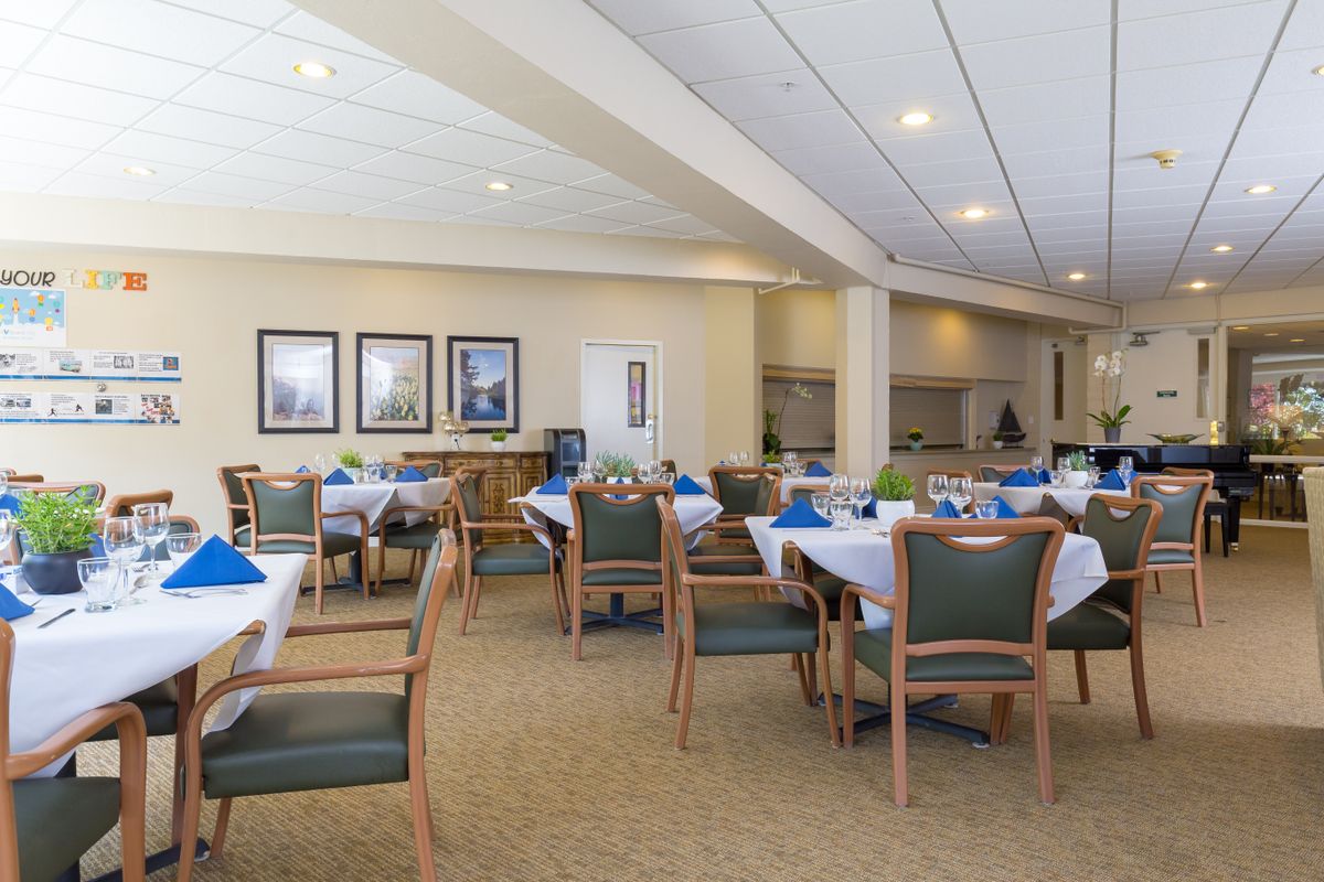 An elegantly set dining area with tables and chairs arranged for guests.