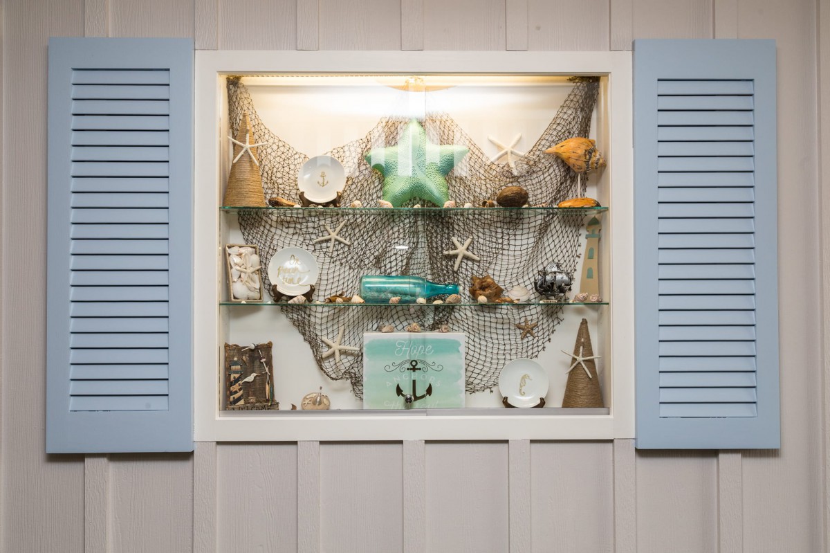 Nautical-themed display with shells, starfish, and anchors.