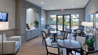 A modern dining area with stylish furniture and large windows.