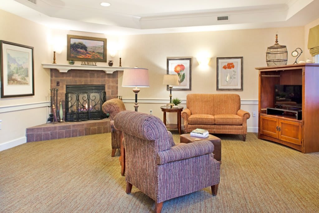 A cozy living room with comfortable seating and a warm fireplace.