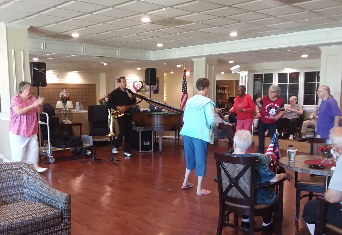 A group of people dancing to live music at an indoor event.
