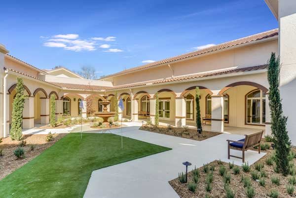 A beautiful courtyard with arched walkways and landscaped gardens.