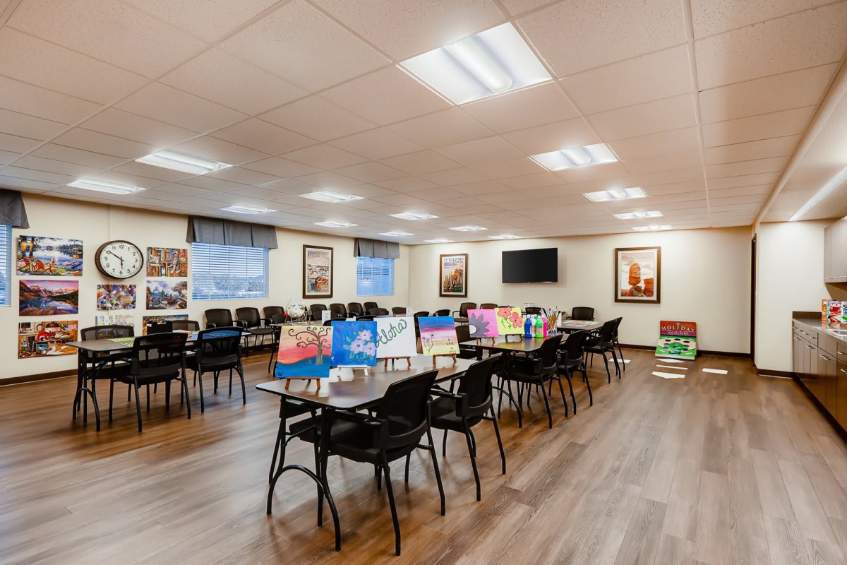 A well-organized conference room with tables and chairs arranged for a meeting or training session.