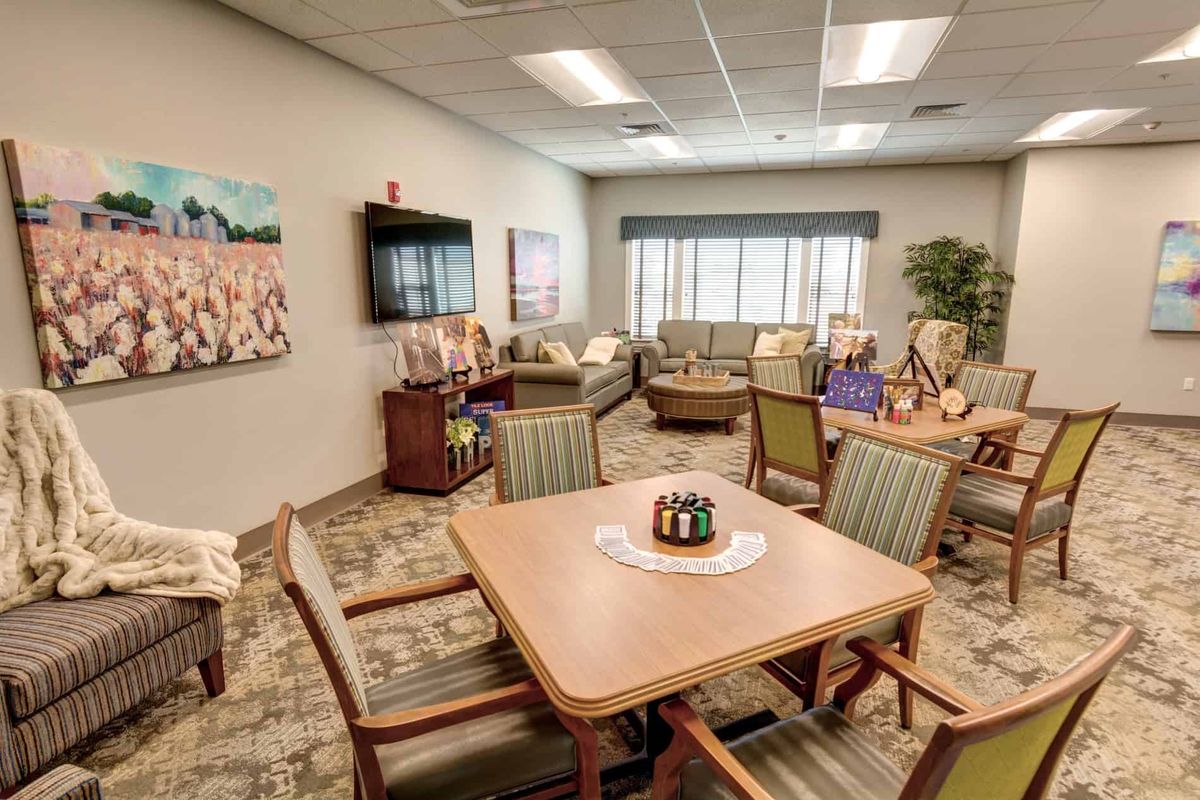 A cozy waiting room with comfortable seating and decorative art.