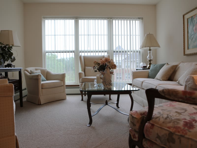 A cozy living room with comfortable seating and large windows.