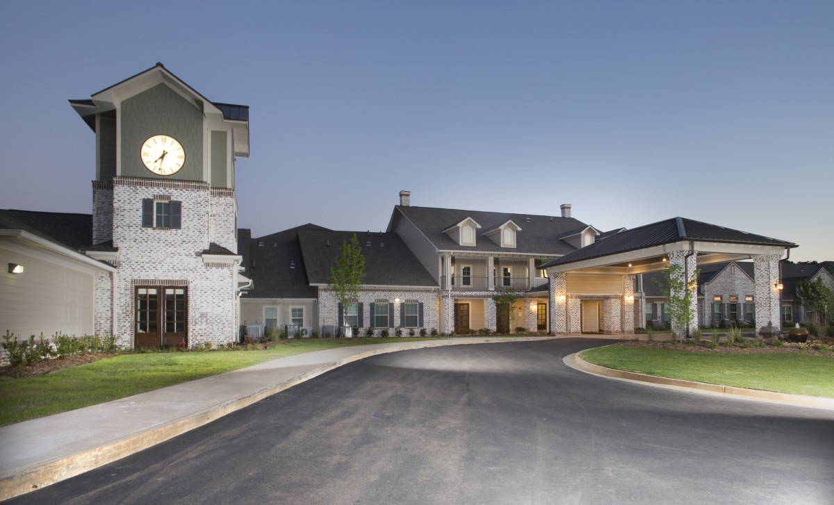 A beautiful residential building with a spacious driveway in the evening.