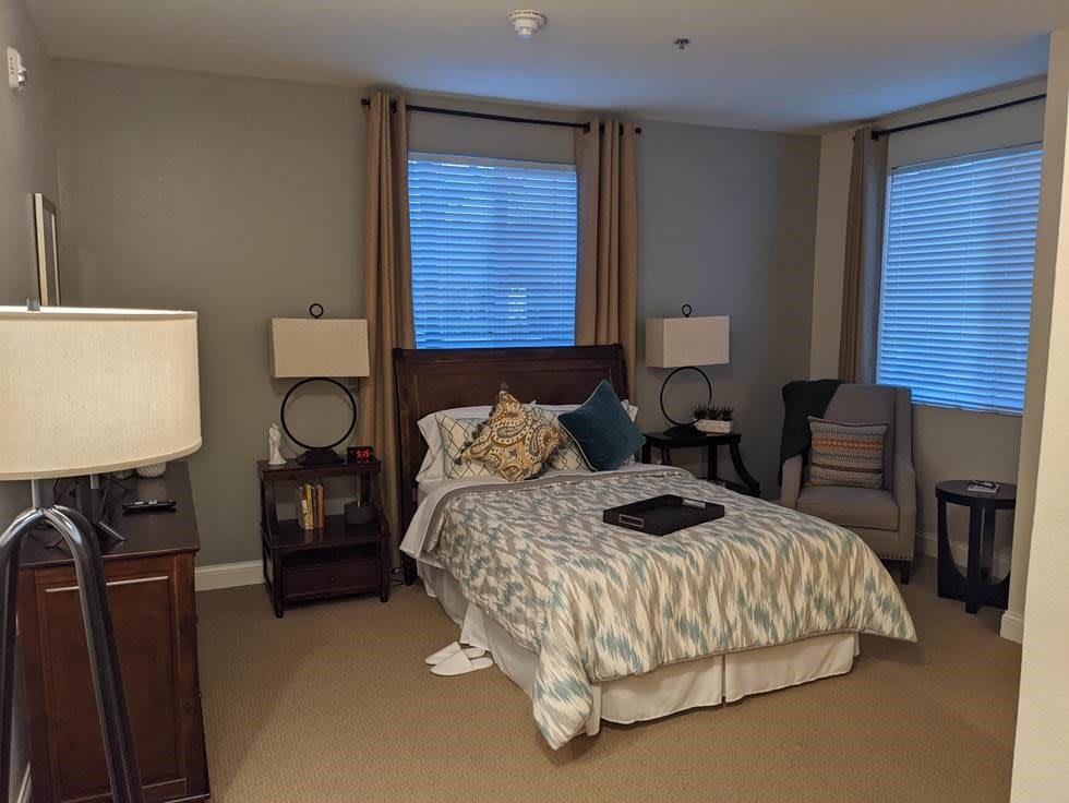 Cozy bedroom with elegant furnishings and soft ambient lighting.