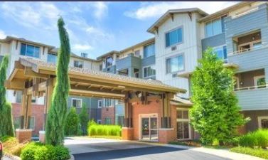 A hotel entrance featuring modern architecture and lush landscaping.