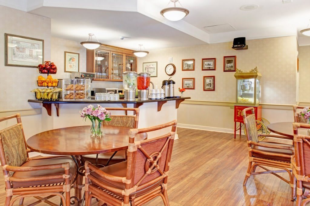 A cozy cafe interior with wooden tables and chairs, adorned with decorative elements and warm lighting.