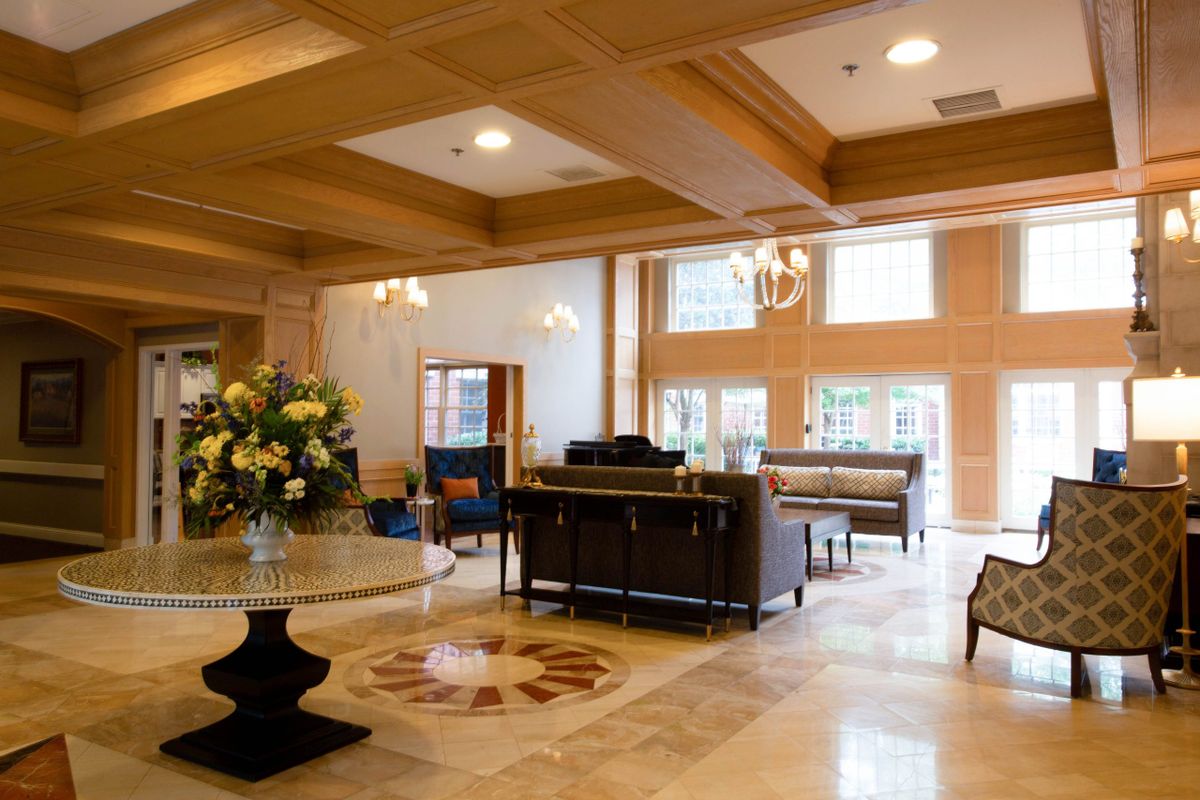 A spacious and elegant lobby with comfortable seating and floral arrangements.