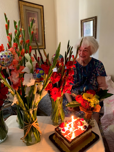 A joyful birthday celebration filled with beautiful flowers and a delicious cake.