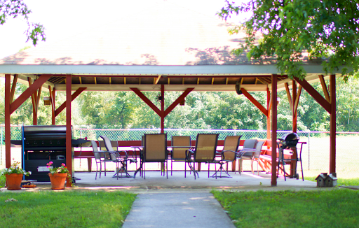 A serene outdoor pavilion with seating, perfect for relaxation by the water.