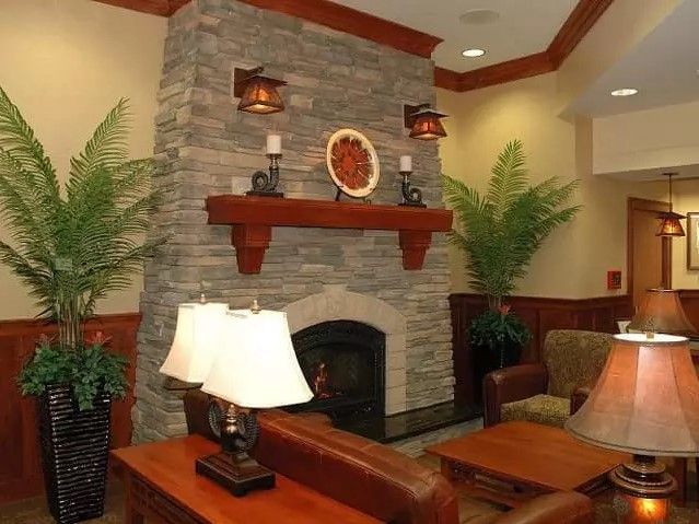A cozy living room with a stone fireplace and elegant decor.