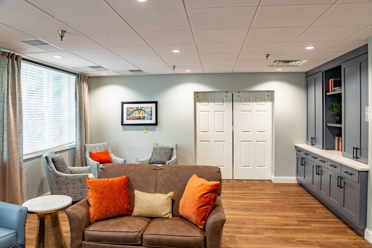 A comfortable living room with modern furniture and bright pillows.