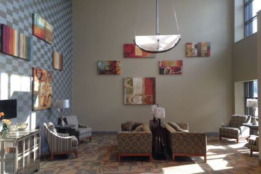 A stylish lobby area featuring modern furniture and artwork on the walls.