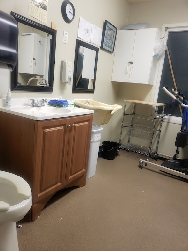 A view of a functional bathroom space with essential fixtures and medical equipment.