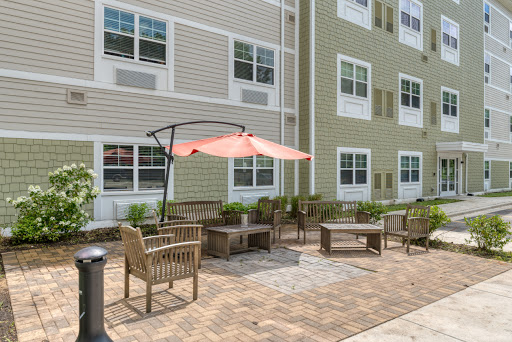 A cozy outdoor patio area with seating and a sunshade, perfect for relaxation.