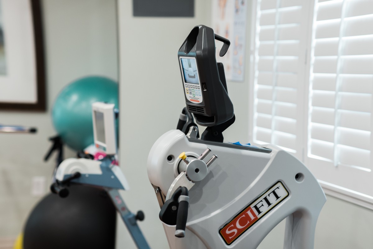 A SCIFIT exercise machine in a gym setting, used for fitness and rehabilitation.