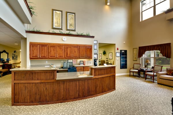 A spacious office lobby with a reception desk and waiting area.