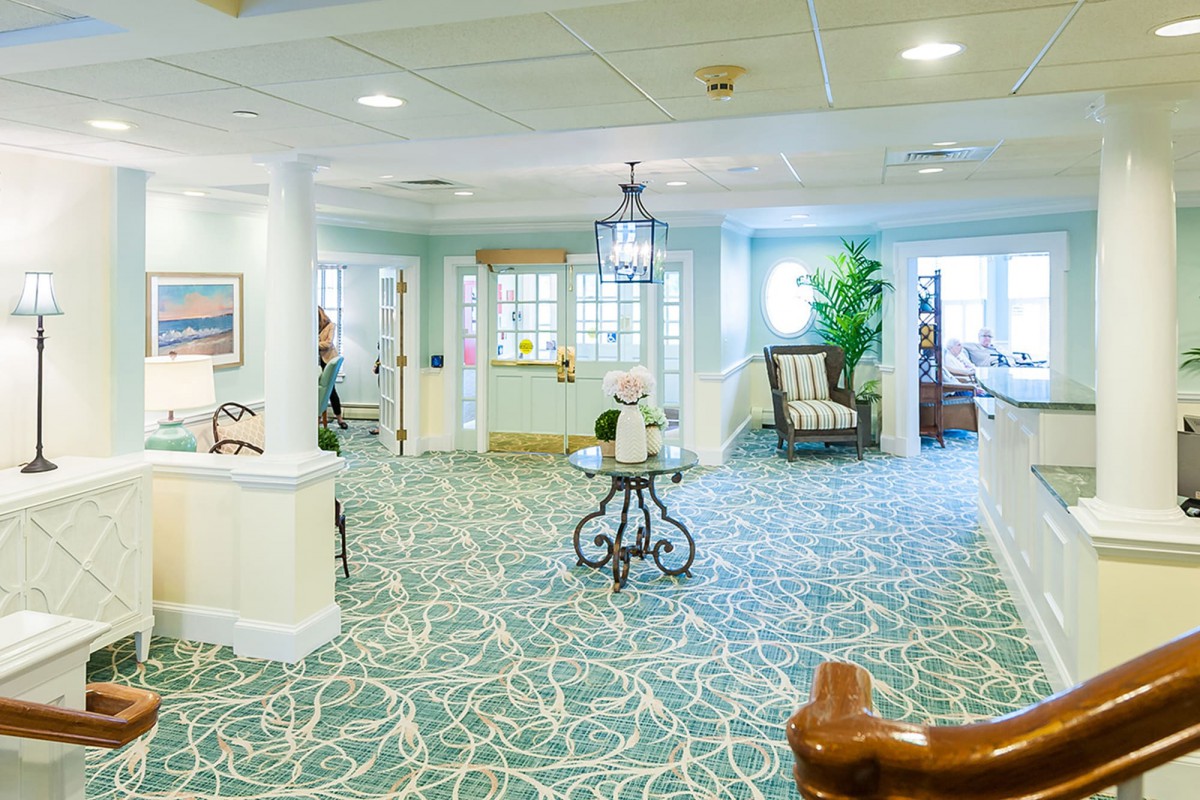 A bright and welcoming lobby area with decorative furniture and carpet.